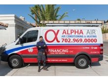 Our AC installation technician is standing in front of a house in Summerlin South Las Vegas ready to replace an AC unit.