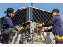 Alpha Air HVAC techs repairing an AC unit in the Las Vegas Valley.